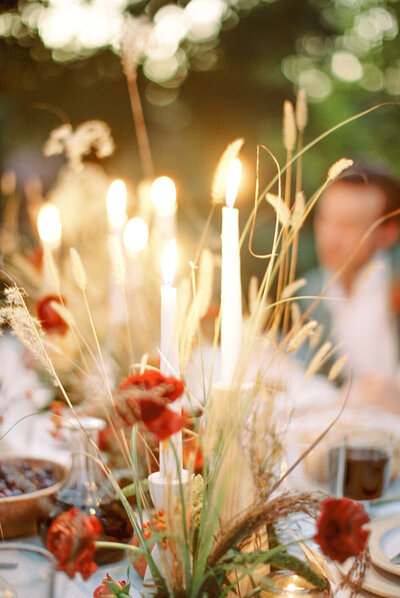 Soft glow of candlelight for a sunset wedding just outside the forest