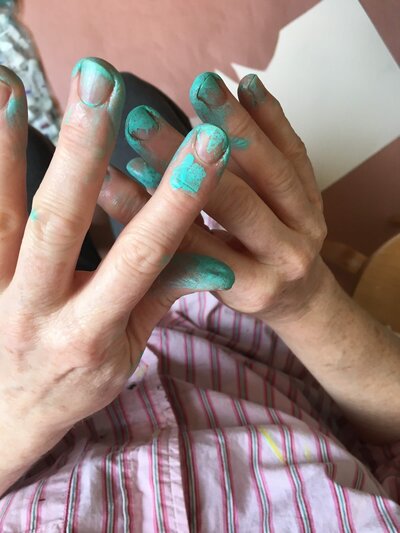Blue paint on Henrie Richer's fingers