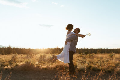 Bride and Groom embracing each other at sunset