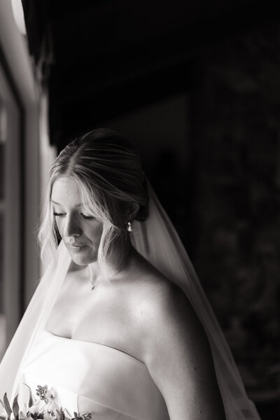 Bride takes a quiet moment in the bridal suite before outdoor Idaho wedding