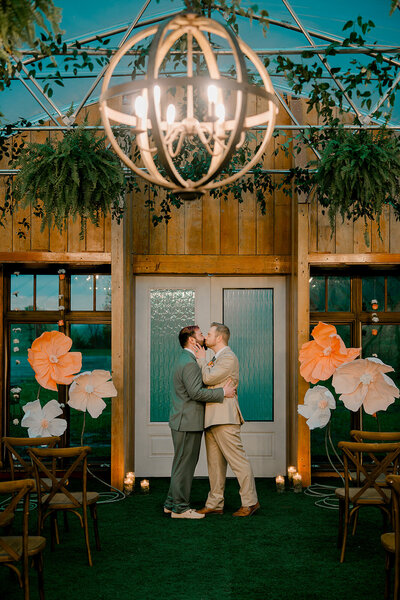 A newlywed couple holding hands and dancing together 