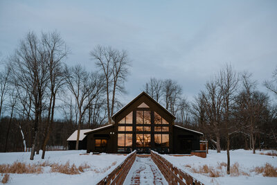 Cabin lit with patio lights at night.