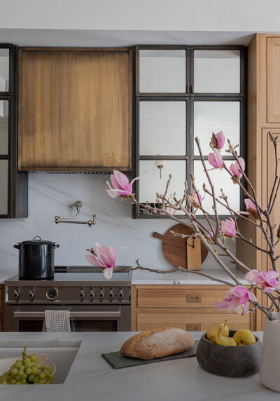 nature inspired kitchen wood cabinets and marble counters