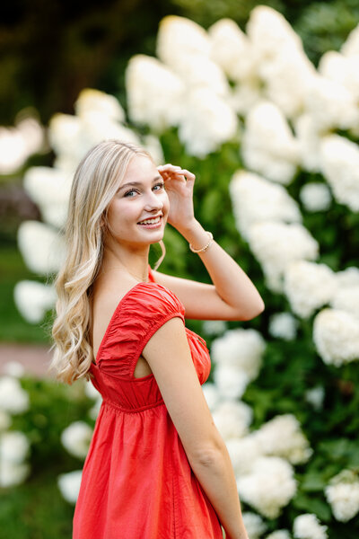 Senior girl smiles at camera during senior photo session in Portsmouth, New Hampshire