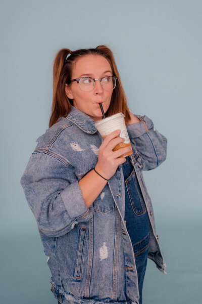 Woman poses for the camera with Farmhouse coffee drink in hand.
