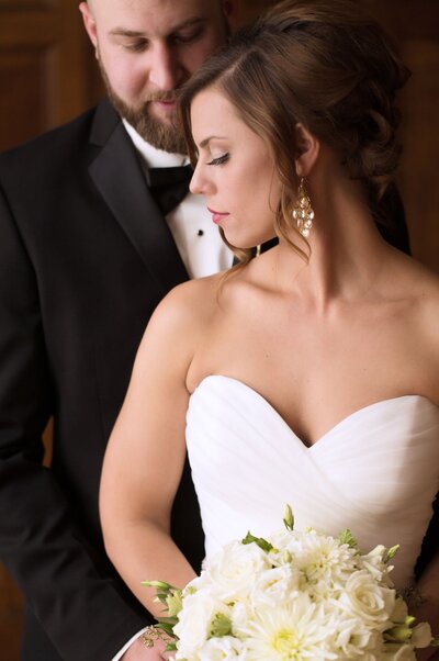 Emotional groom holds bride after first look.