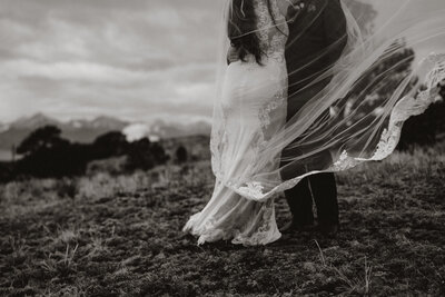 Wind catching bride's veil during an elopement in Breckenridge’s scenic mountain landscape.