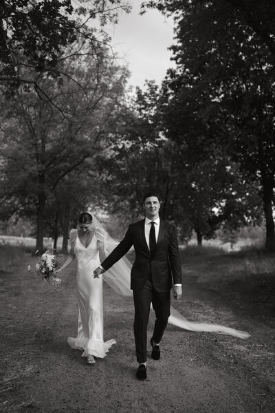 bride and groom walking holding hands