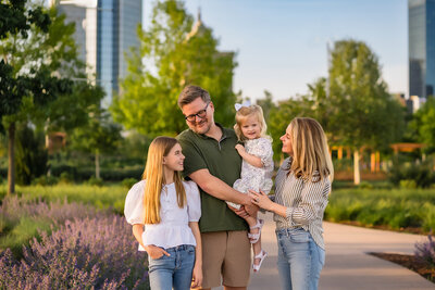 a family of five is photographed by the lake