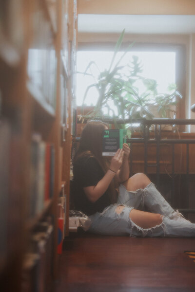 KP sitting and holding a book