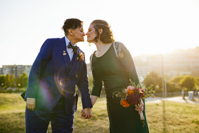 Two Brides kissing during Golden Hour at Seattle Center For Wooden Boats