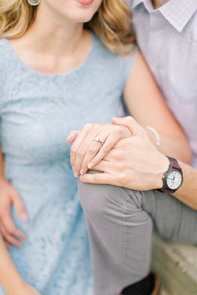 couple holding hands while at their engagement session