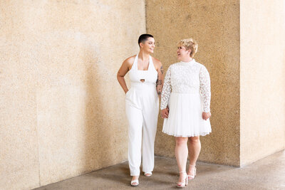 women wearing white outfits looking at each other