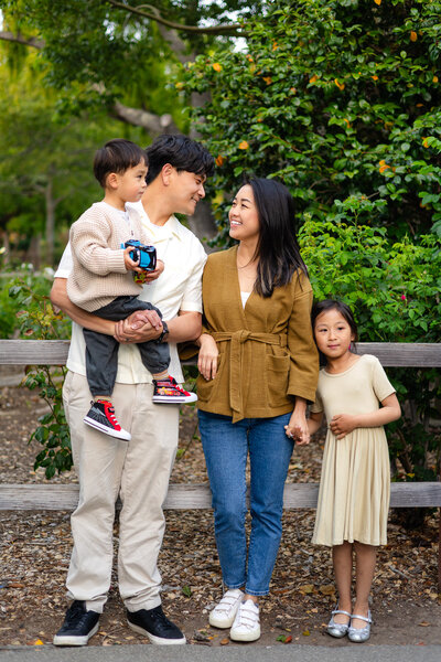 Family of four sharing a joyful moment in a garden setting – Bay Area Family Portfolio - Ellobelle Photography Family Photographer