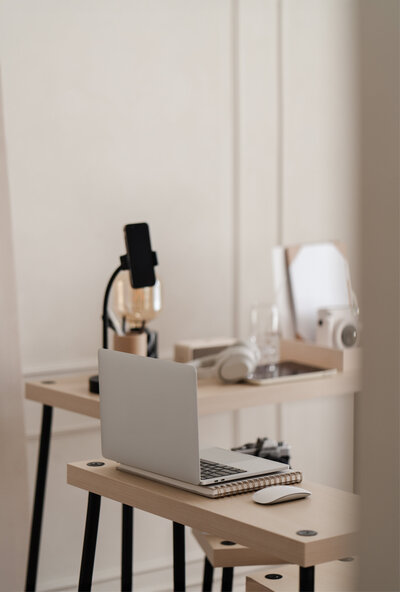 A MacBook sitting on a modern office desk displaying the 'How To Add Your Showit Template Key To Your Website' guide, highlighting a resource designed to help website owners easily integrate their Showit template for seamless functionality.