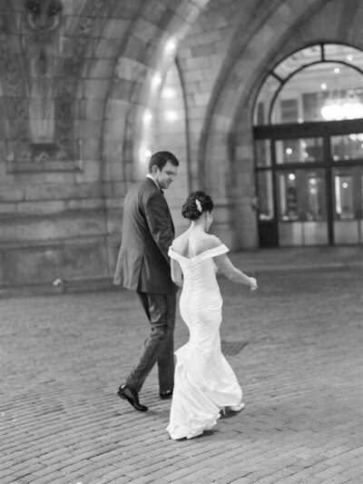 Bride and groom walk under the lights at the Pennsylvanian in Pittsburgh, PA at their Shayla Hawkins Events planned wedding as Anna Laero Photography documents their wedding.