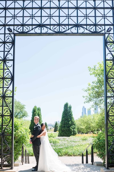 Bride and groom portraits next to a iron scrollwork gate