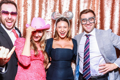 guests posing against a blush sequins backdrop for a luxury photo booth experience