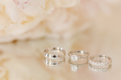 Wedding rings on glass with reflection
