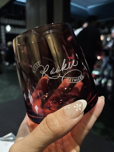 Custom calligraphy on a smoky wine glass