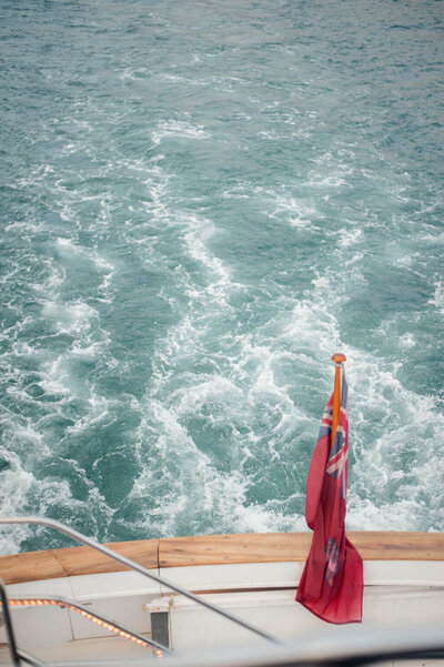 boat in ocean with red flag