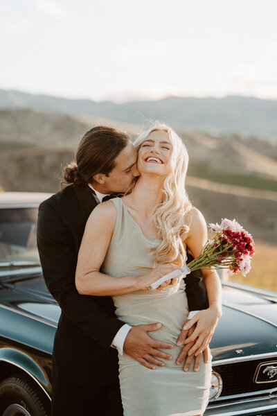 couple-kissing-and-laughing-on-photoshoot