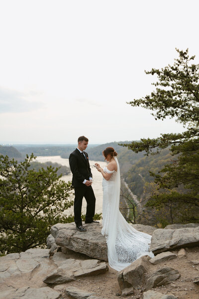 A bride and a groom between two trees during their wedding ceremony in Austin, Texas. 
