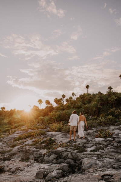 couple walk together on beach in MEXICO