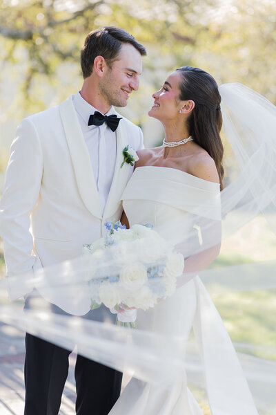 bride and groom smiling at each other at Ma Maison