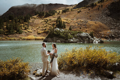 groom kissing bride's forehead