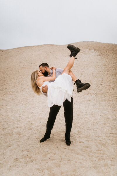 couple holding one another in the desert