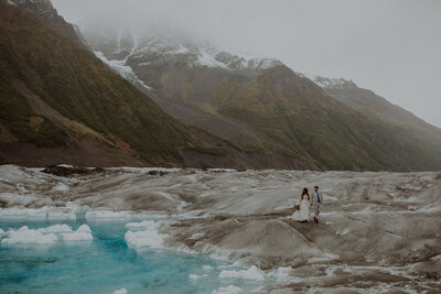 Bride and groom walk on a glacier in Alaska for their elopement