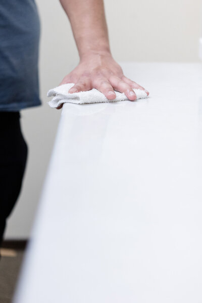 Professional cleaner wiping down break room table