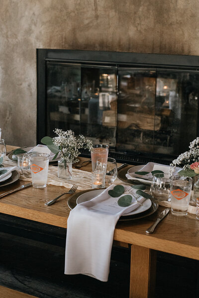 Romantic rustic tablescape with textured florals, candlelight, and vintage details at South Block Barbecue & Brewing Co. in Calgary, designed by Melissa Alison Events.
