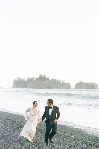 wedding couple running on the beach