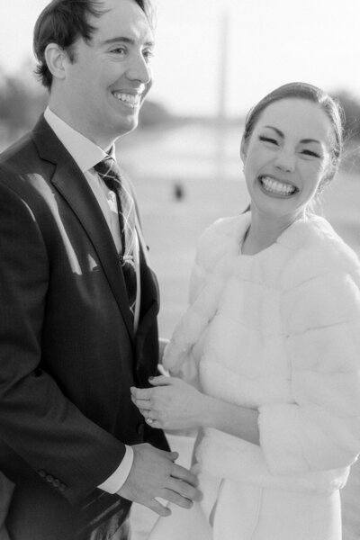 A beaming bride and groom share a joyful moment on their wedding day, beautifully captured by a timeless natural light wedding photographer.