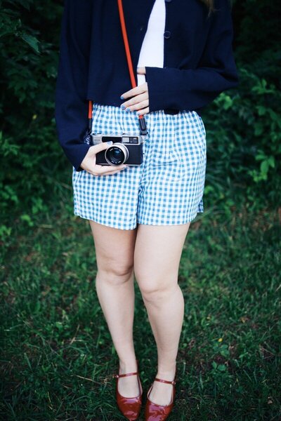 Sammy Mckenzie, wedding photographer in Middle Tennessee, holding camera