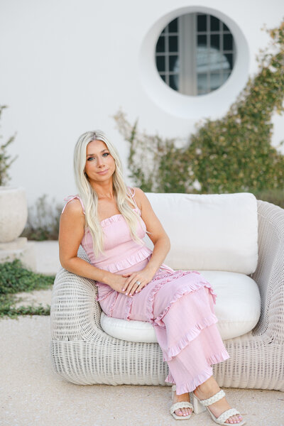 Addison smiling in a pink romper
