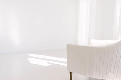 photo of Laurie Baker's natural light photography studio, all white room with white floors and white walls