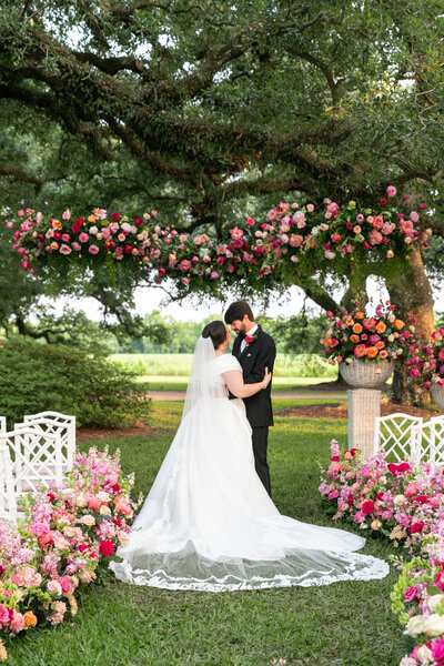 Garden wedding with bright floral for bride and groom photos