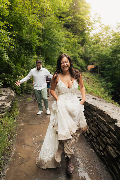 bride with muddy dress hiking on her elopement day