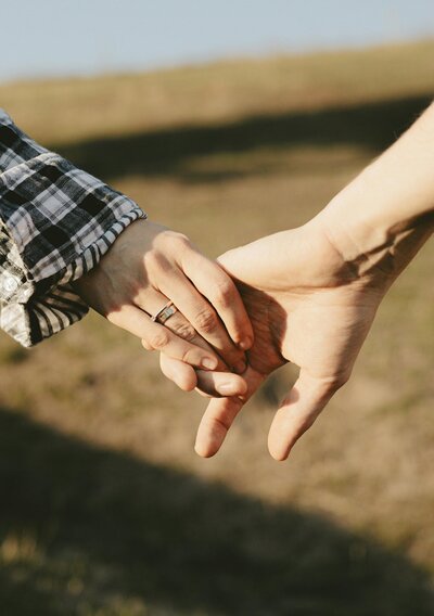 Couple holding hands, booking micro wedding packages in Texas at The Bellspring