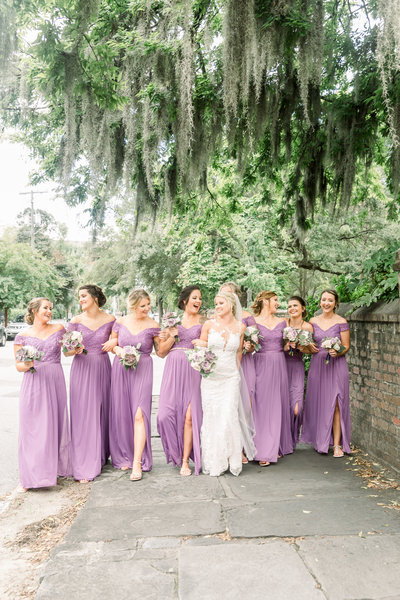Bridal party walks down street at Old Wide Awake Plantation in South Carolina.