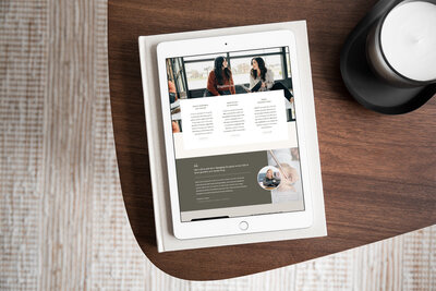 Ipad on a wooden coffee table with website up