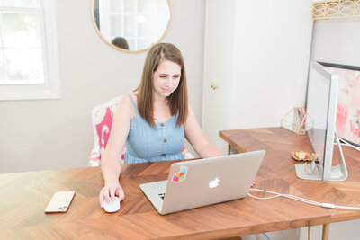 woman working on her laptop on a walnut desk