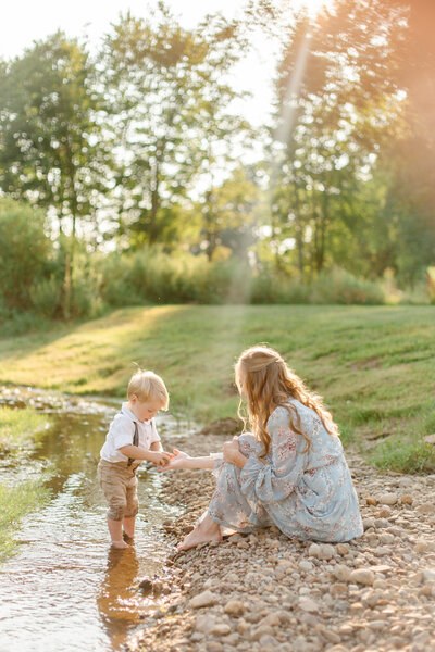Boy playing with mom in creek