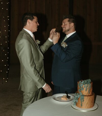 Couple feeding each other their first taste of their wedding cake
