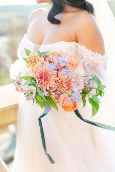 Bride holding colorful bouquet at the Estate at River Run in Maidens, Virginia. Captured by Bethany Aubre Photography.