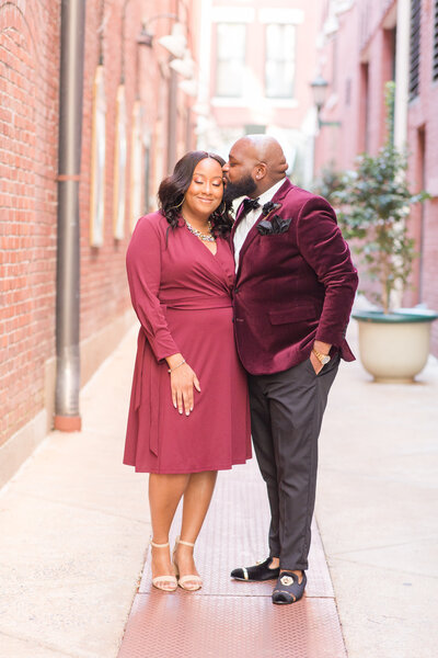 man and woman smiling at each other during their engagement session in downtown memphis tennesses