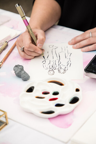 Stephanie Anne Illustration's watercolor sketching process, showing artist's hand creating detailed figure drawings